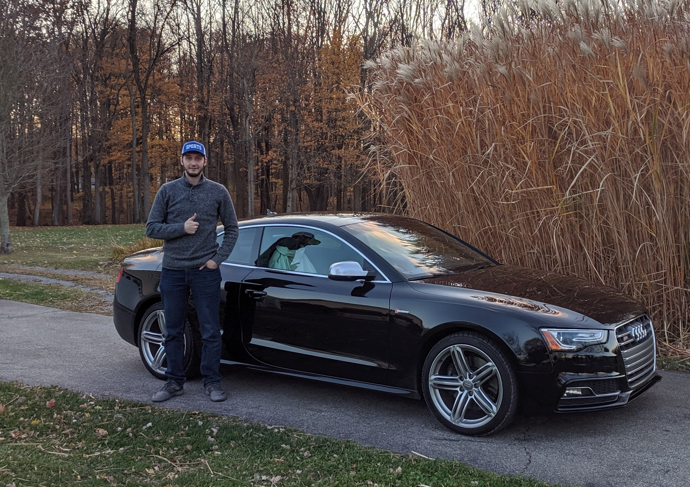 Two goofball Engineers standing in front of Black car